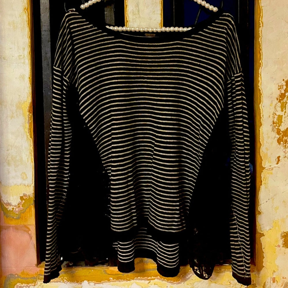Long sleeve Free people black and white stripped top size XS with lace on side.