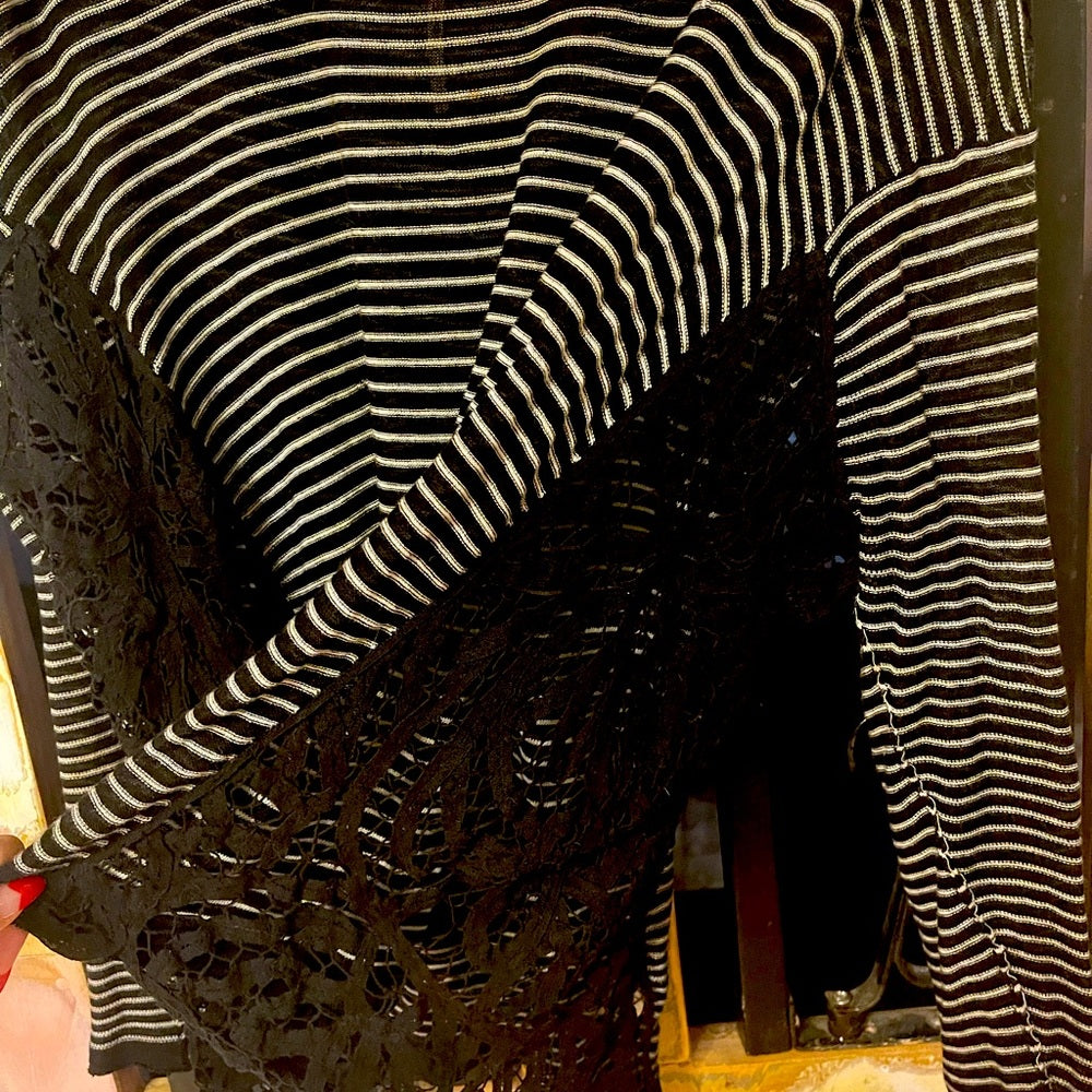 Long sleeve Free people black and white stripped top size XS with lace on side.