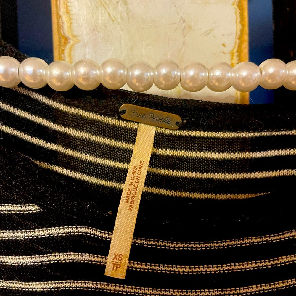 Long sleeve Free people black and white stripped top size XS with lace on side.