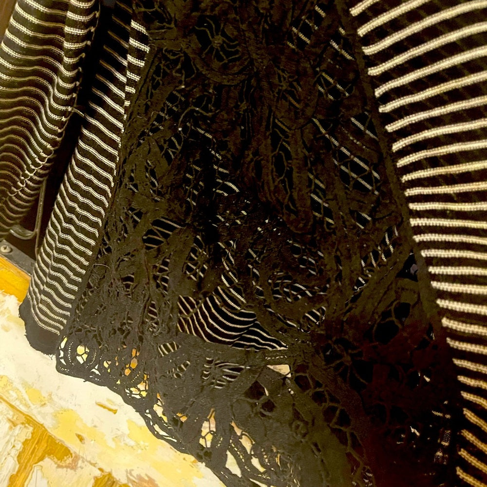 Long sleeve Free people black and white stripped top size XS with lace on side.