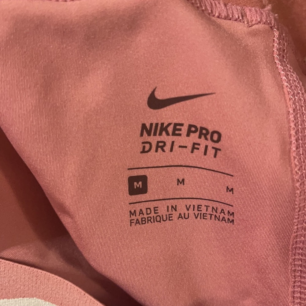 Bundle Nike & under Armour pink and purple leggings. Size M